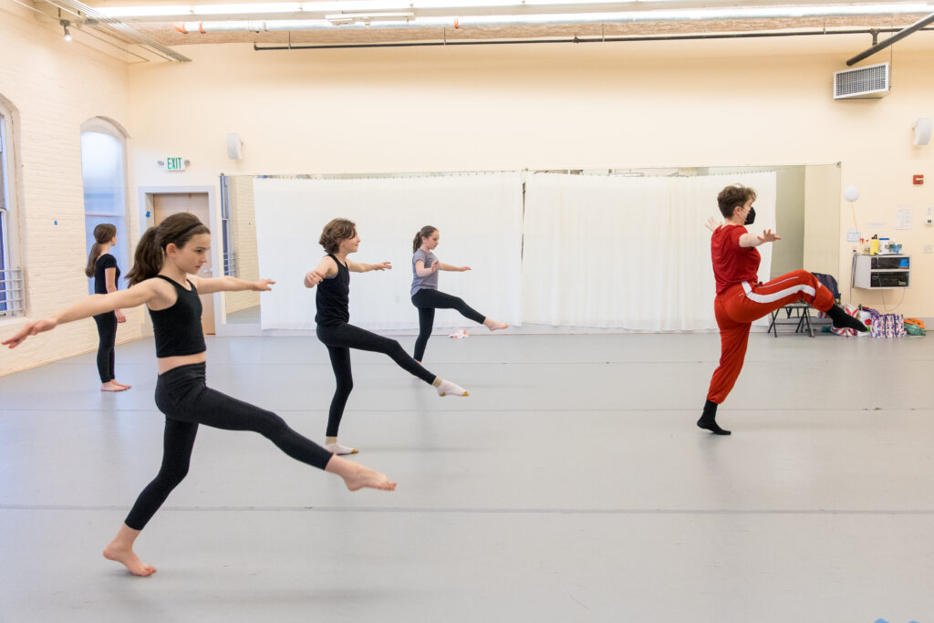 Dancers following their instructor in a studio