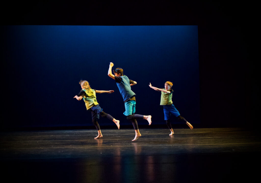 Three boys dancing onstage