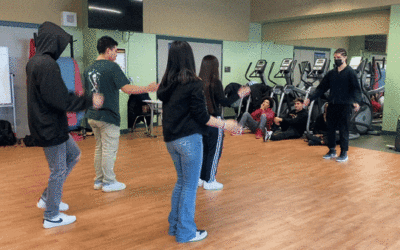 group of students learning step dance