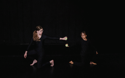 dancers performing in a dark room